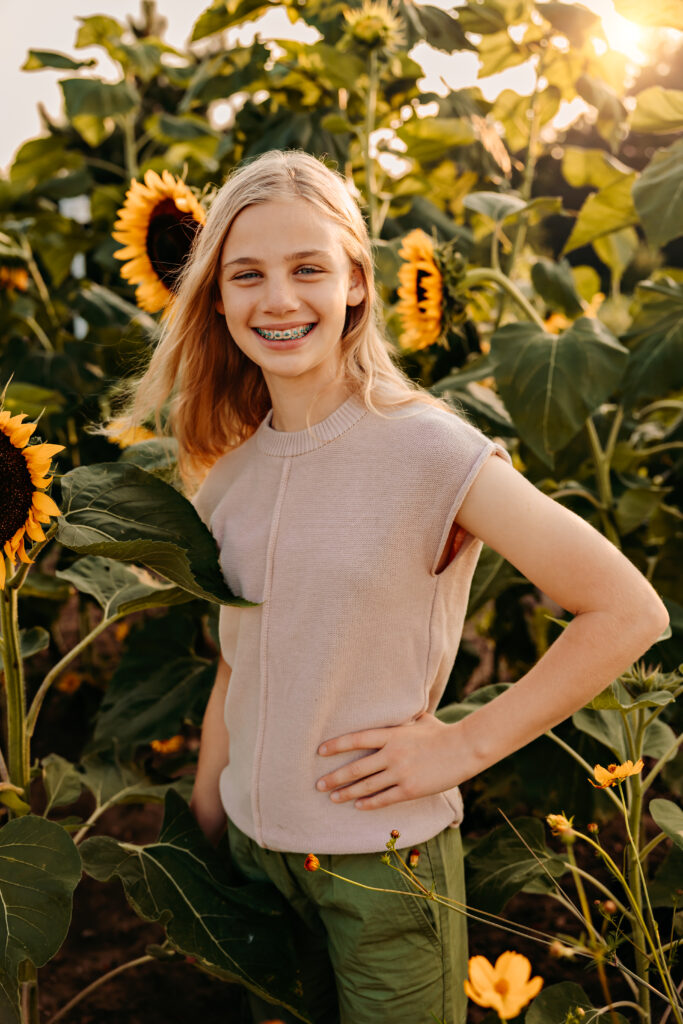 Teenage girl smiling in a sunflower field