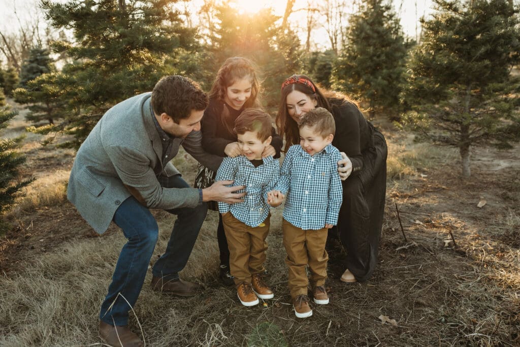 Family of 5 having fun during tree farm photos