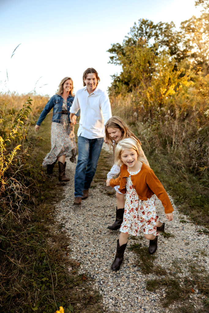 Family walking hand in hand during a fall family photography session in Barrington, Illinois.