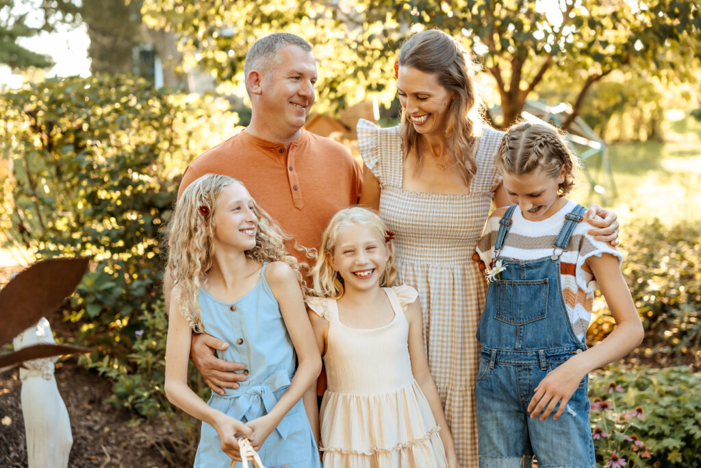 Parents and kids laughing together during a family photo session in Crystal Lake, IL