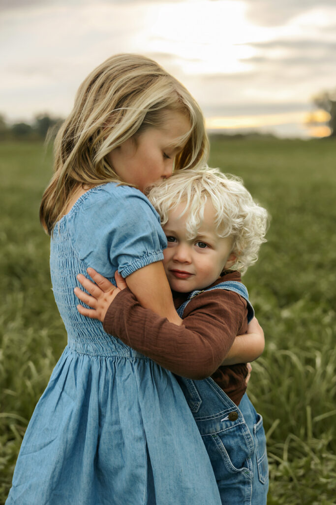 Siblings hugging in their coordinated outfits for family photos in crystal lake, IL